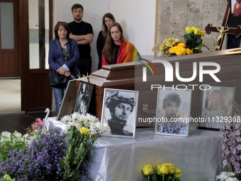 Photographs are being pictured at the coffin during the memorial service of Ukrainian serviceman, artist, musician, stylist, and queer commu...