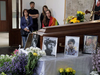 Photographs are being pictured at the coffin during the memorial service of Ukrainian serviceman, artist, musician, stylist, and queer commu...