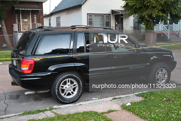 A vehicle is being damaged by bullet holes at the crime scene. Four people are being shot in a mass shooting in Chicago, Illinois, United St...