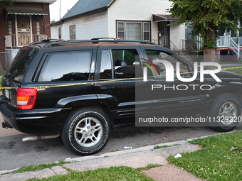 A vehicle is being damaged by bullet holes at the crime scene. Four people are being shot in a mass shooting in Chicago, Illinois, United St...