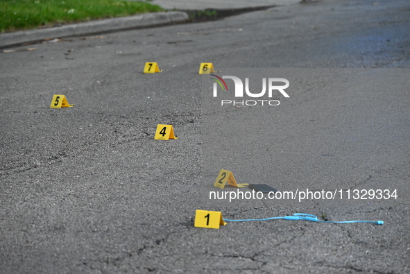 Evidence markers on the ground are showing where a cell phone, USB charger, and shell casings are at the scene of an early morning mass shoo...