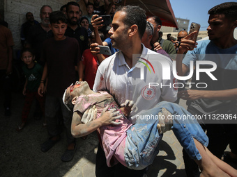 An injured girl is being brought to the al-Aqsa Martyrs Hospital in Deir al-Balah, in the central Gaza Strip, following the Israeli bombardm...