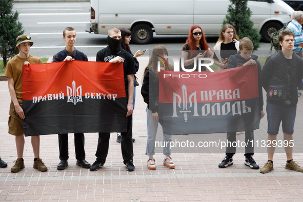 Demonstrators with flags of the Right Sector and the Right Youth are holding a protest action outside the Kyiv City State Administration aga...