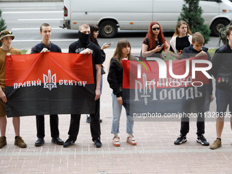 Demonstrators with flags of the Right Sector and the Right Youth are holding a protest action outside the Kyiv City State Administration aga...