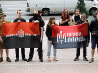 Demonstrators with flags of the Right Sector and the Right Youth are holding a protest action outside the Kyiv City State Administration aga...