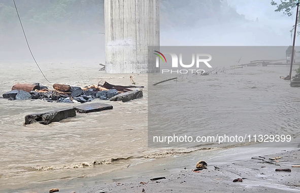 A view of the Teesta River as the waters are entering the roads and houses due to the risen water level of the river, which is flowing besid...