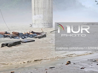 A view of the Teesta River as the waters are entering the roads and houses due to the risen water level of the river, which is flowing besid...