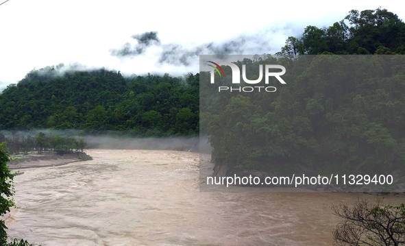 A view of the Teesta River as the waters are entering the roads and houses due to the risen water level of the river, which is flowing besid...