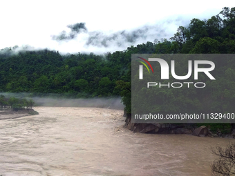 A view of the Teesta River as the waters are entering the roads and houses due to the risen water level of the river, which is flowing besid...