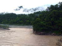 A view of the Teesta River as the waters are entering the roads and houses due to the risen water level of the river, which is flowing besid...