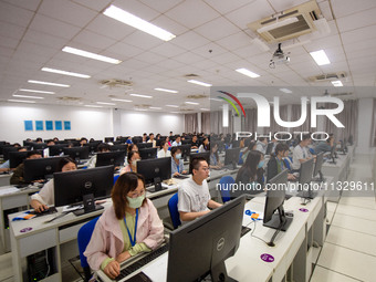 A marking teacher is carefully evaluating a college entrance examination paper at a marking point at a college in Nanjing, China, on June 14...