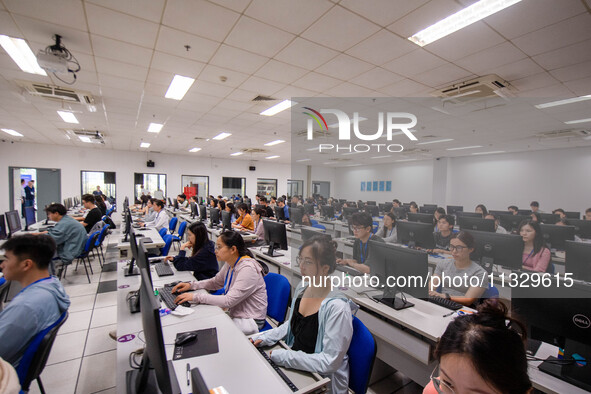 A marking teacher is carefully evaluating a college entrance examination paper at a marking point at a college in Nanjing, China, on June 14...