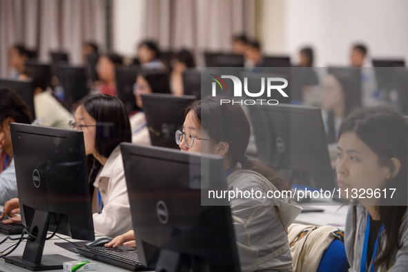 A marking teacher is carefully evaluating a college entrance examination paper at a marking point at a college in Nanjing, China, on June 14...