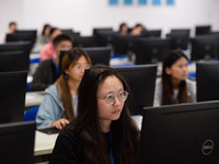 A marking teacher is carefully evaluating a college entrance examination paper at a marking point at a college in Nanjing, China, on June 14...