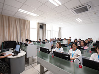 A marking teacher is carefully evaluating a college entrance examination paper at a marking point at a college in Nanjing, China, on June 14...