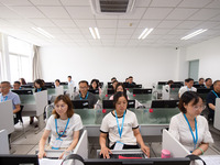 A marking teacher is carefully evaluating a college entrance examination paper at a marking point at a college in Nanjing, China, on June 14...