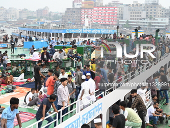 Passengers are gathering at the launch terminal for ferries as they are traveling back to their villages from the capital Dhaka to celebrate...