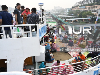 Passengers are gathering at the launch terminal for ferries as they are traveling back to their villages from the capital Dhaka to celebrate...