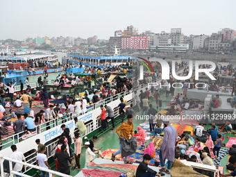 Passengers are gathering at the launch terminal for ferries as they are traveling back to their villages from the capital Dhaka to celebrate...