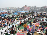 Passengers are gathering at the launch terminal for ferries as they are traveling back to their villages from the capital Dhaka to celebrate...