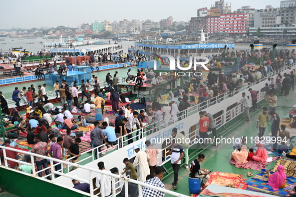 Passengers are gathering at the launch terminal for ferries as they are traveling back to their villages from the capital Dhaka to celebrate...