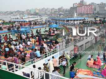 Passengers are gathering at the launch terminal for ferries as they are traveling back to their villages from the capital Dhaka to celebrate...