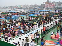 Passengers are gathering at the launch terminal for ferries as they are traveling back to their villages from the capital Dhaka to celebrate...