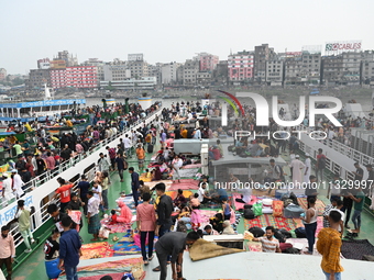 Passengers are gathering at the launch terminal for ferries as they are traveling back to their villages from the capital Dhaka to celebrate...