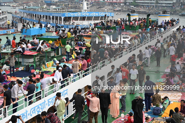 Passengers are gathering at the launch terminal for ferries as they are traveling back to their villages from the capital Dhaka to celebrate...