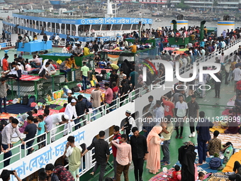 Passengers are gathering at the launch terminal for ferries as they are traveling back to their villages from the capital Dhaka to celebrate...