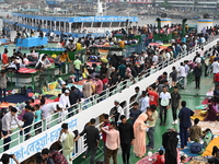 Passengers are gathering at the launch terminal for ferries as they are traveling back to their villages from the capital Dhaka to celebrate...