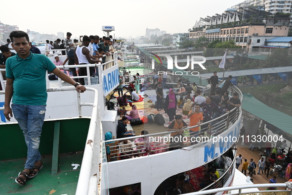 Passengers are gathering at the launch terminal for ferries as they are traveling back to their villages from the capital Dhaka to celebrate...