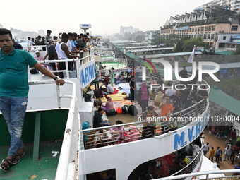 Passengers are gathering at the launch terminal for ferries as they are traveling back to their villages from the capital Dhaka to celebrate...