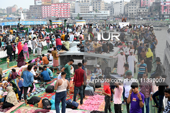 Passengers are gathering at the launch terminal for ferries as they are traveling back to their villages from the capital Dhaka to celebrate...