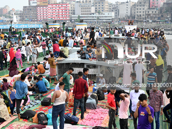 Passengers are gathering at the launch terminal for ferries as they are traveling back to their villages from the capital Dhaka to celebrate...