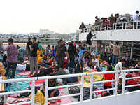 Passengers are gathering at the launch terminal for ferries as they are traveling back to their villages from the capital Dhaka to celebrate...