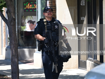 A police officer with tactical gear is executing a search warrant at Oakton Spa. Homeland Security Investigations Agents and Skokie Police a...