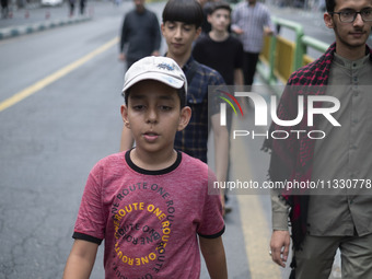 Young Iranian men are walking along Enghelab (Revolution) Avenue, as they are making their way to the University of Tehran for Friday prayer...