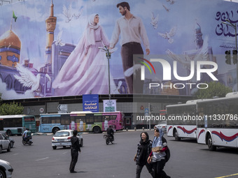 Two young Iranian women are passing an avenue in downtown Tehran, Iran, on June 14, 2024, during Iran's early presidential election campaign...