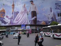 Two young Iranian women are passing an avenue in downtown Tehran, Iran, on June 14, 2024, during Iran's early presidential election campaign...