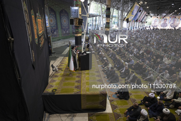 Leader of Tehran's Friday prayers, Ahmad Khatami (C), is delivering a sermon during prayer ceremonies at the University of Tehran, amidst th...