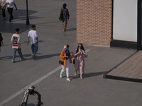 Iranian youths are walking along a recreation area in western Tehran, Iran, on June 14, 2024, amidst the early presidential election campaig...