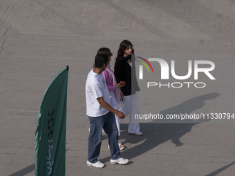 Iranian youths are walking along a recreation area in western Tehran, Iran, on June 14, 2024, amidst the early presidential election campaig...