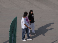 Iranian youths are walking along a recreation area in western Tehran, Iran, on June 14, 2024, amidst the early presidential election campaig...