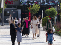 An Iranian family is walking along a recreation area in western Tehran, Iran, on June 14, 2024, amidst the early presidential election campa...