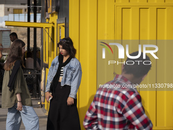 Two young Iranian women are standing together in a recreation area in western Tehran, Iran, on June 14, 2024, amidst the early presidential...