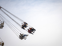 Iranian youths are riding on a star flyer in a recreation area in western Tehran, Iran, on June 14, 2024, amidst the early presidential elec...