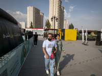 Iranian youths are walking along a recreation area in western Tehran, Iran, on June 14, 2024, amidst the early presidential election campaig...