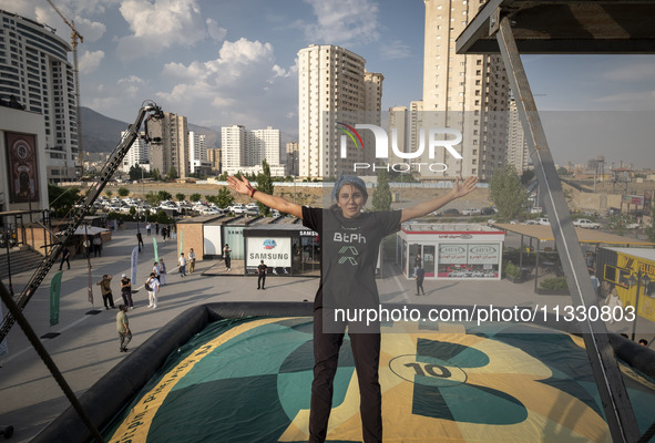 Sogand Salari, an Iranian diver, is performing while jumping during a street diving event organized and held by Tehran's Adrenaline Park, in...