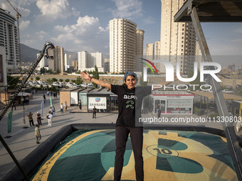 Sogand Salari, an Iranian diver, is performing while jumping during a street diving event organized and held by Tehran's Adrenaline Park, in...